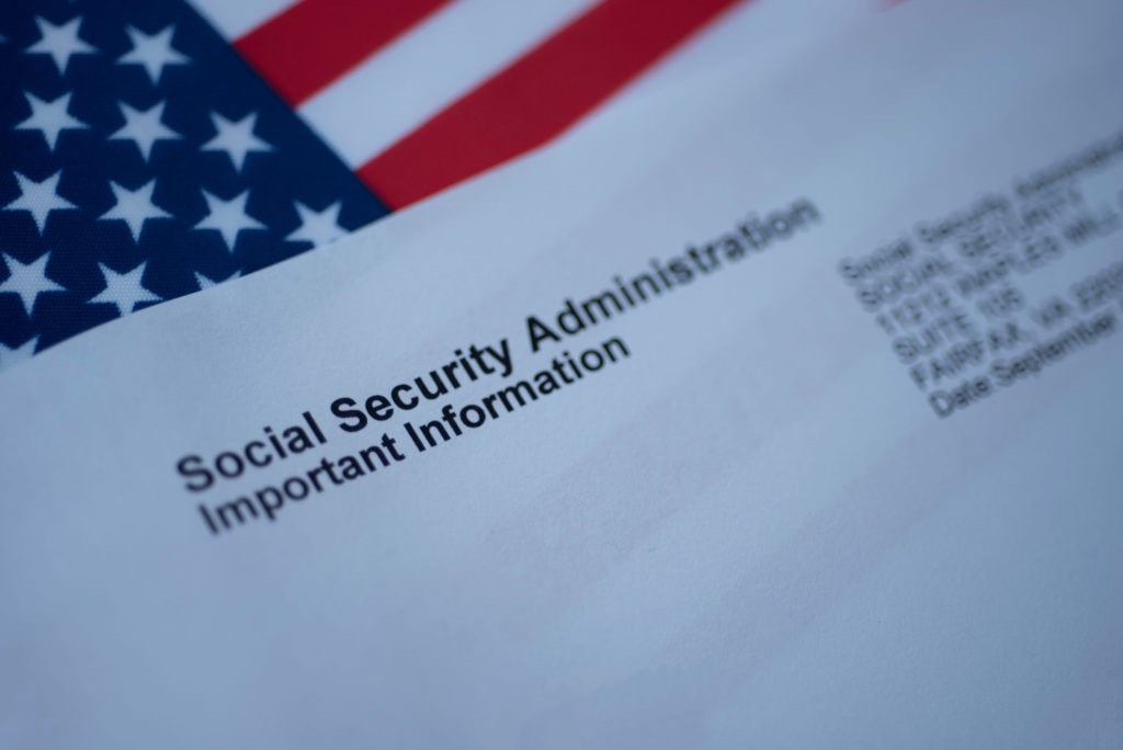 Social Security Administration Important Information letter next to flag of USA.